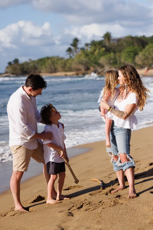 Family of four laughing during sunset portrait session in San Juan